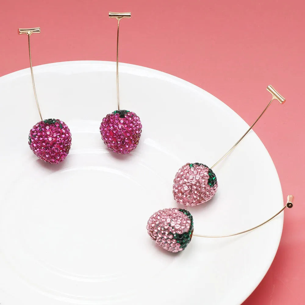Geometric strawberry-shaped zinc alloy earrings with spot-drill texture, shown in red, on a white background.