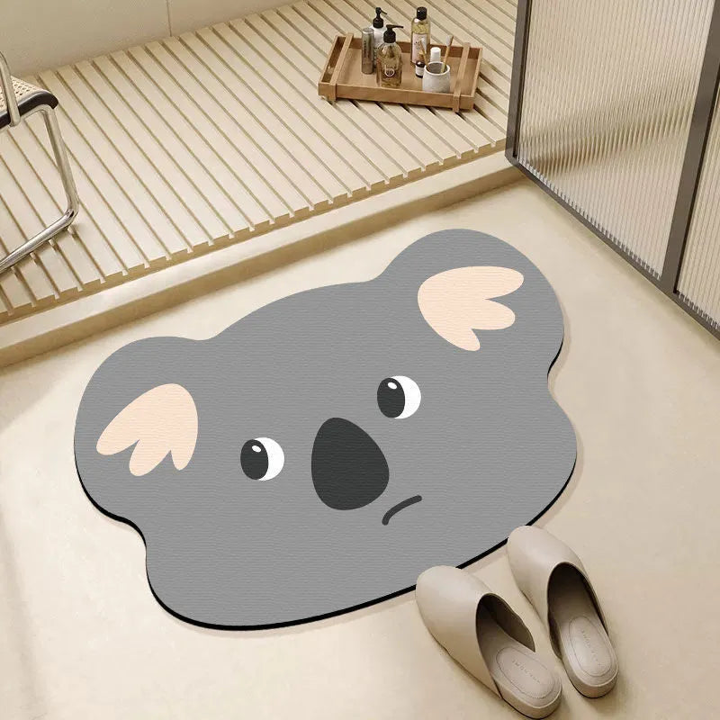 Cartoon animal diatom absorbent bathroom mat in bear pattern on tiled floor.