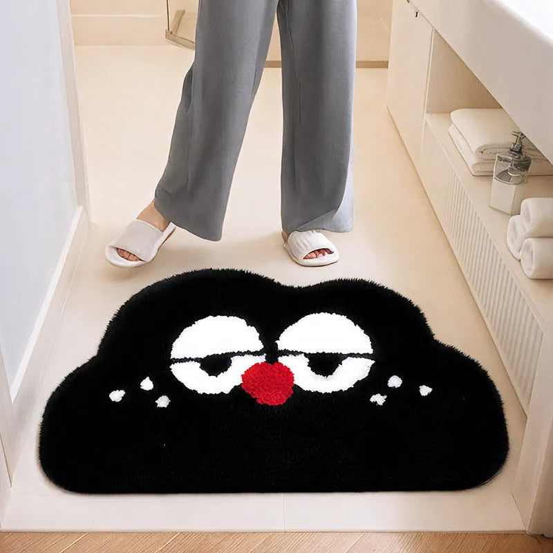 Big eye clouds cartoon patterned bathroom mat in soft green on a bathroom floor.