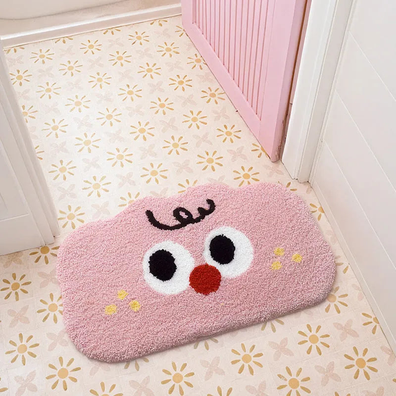Big eye clouds cartoon patterned bathroom mat in soft green on a bathroom floor.
