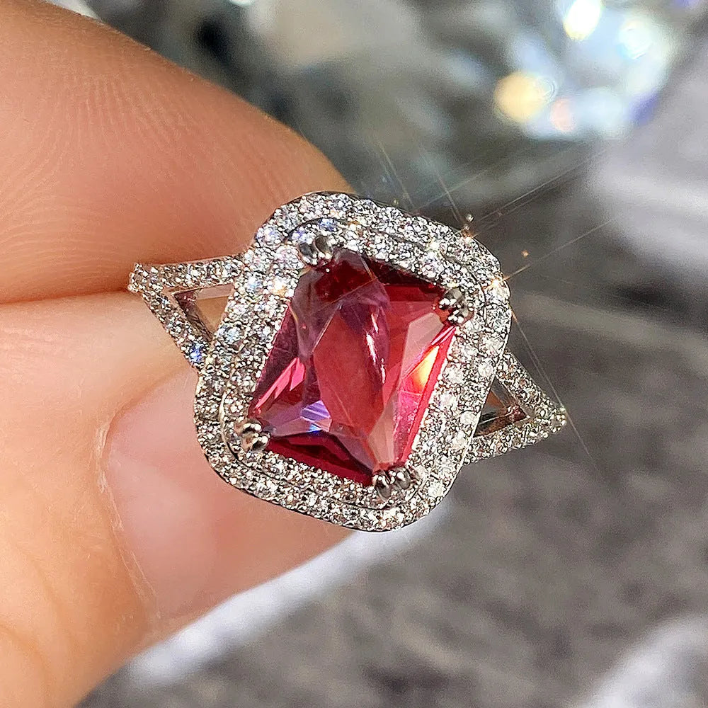 Women's copper ring with a square red rhinestone centrepiece on a geometric band.