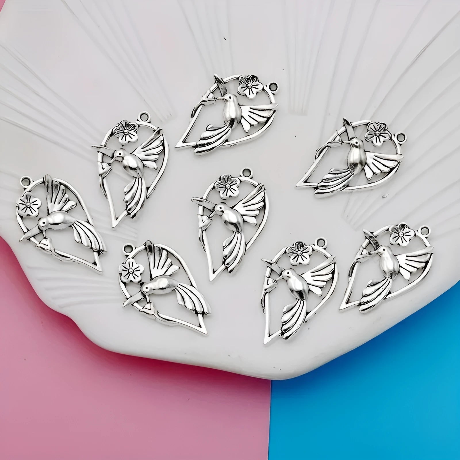 Close-up of a silver-toned magpie-shaped alloy pendant for DIY jewellery making, showing detailed feathers.