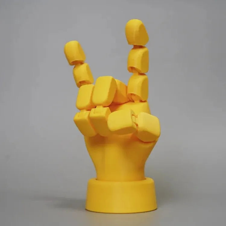 Yellow movable joint hand ornament figurine made of PLA plastic on a plain background