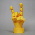 Yellow movable joint hand ornament figurine made of PLA plastic on a plain background