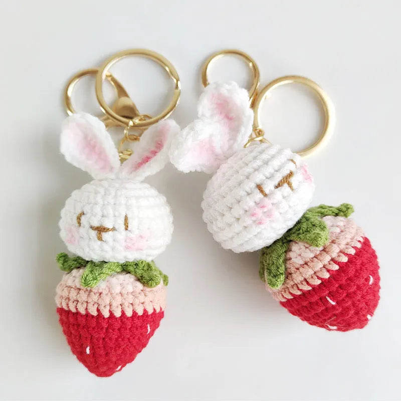 Hand-woven white rabbit strawberry wire pendant charm on a keyring.
