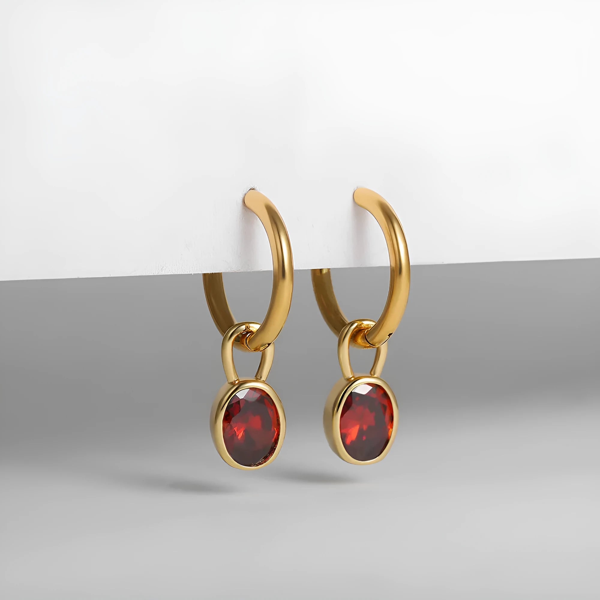 Close-up of women's simple oval zircon stud earrings in copper, showing army green and emerald colour options on a white background.