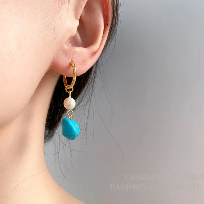 Geometric turquoise and cultured pearl drop earrings and short earrings set on copper base.