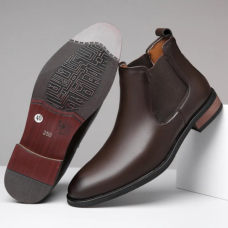 Men's black Chelsea boots with pointed toe design, sewing thread details and rubber sole