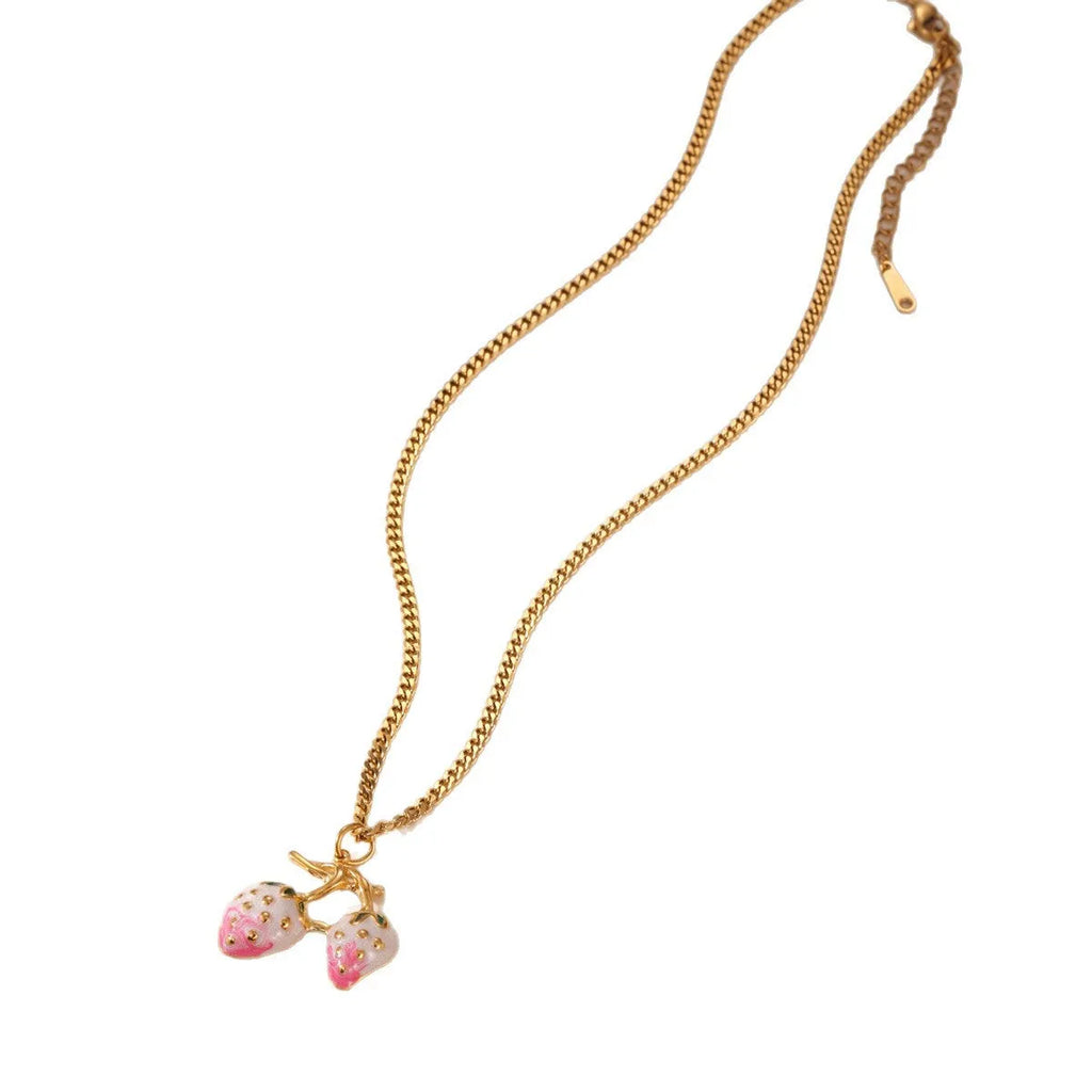 Close-up of a strawberry-shaped alloy pendant necklace on a stainless steel chain, showing red and white colour options.
