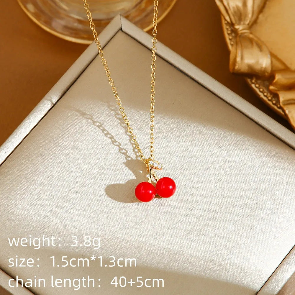 Red delicate indie necklace with cherry, strawberry, and pepper charms on a titanium steel O-ring chain.
