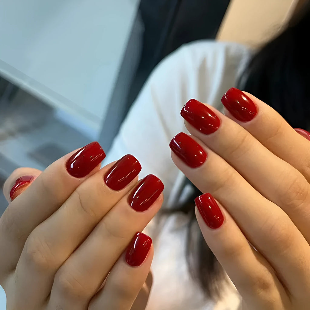 Short solid colour false nails in New Year red with marble pattern, 24 pieces per box with glue for ladies.