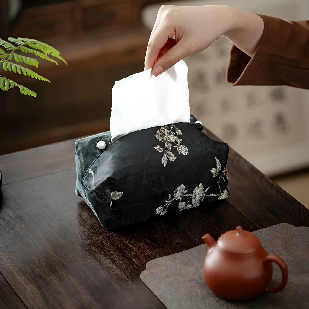 New Chinese style white brocade tissue box cover with embroidered plum blossoms on a table.