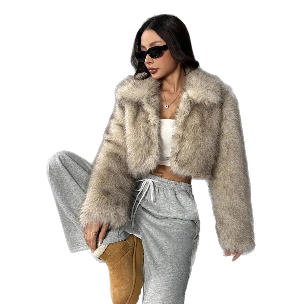 Women's short black and white artificial fur coat with a large fur collar, shown in a cute style pose.