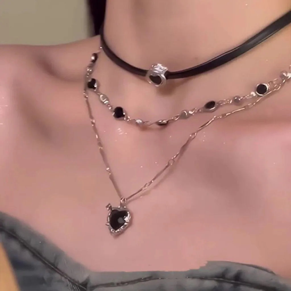Women's twin necklace set showing leather and alloy heart pendants on an adjustable chain