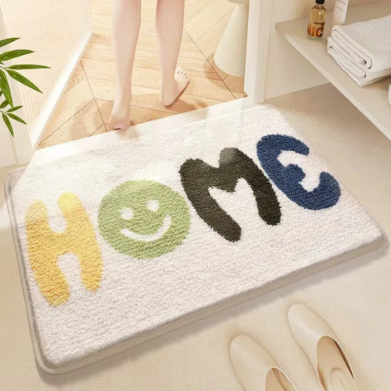 Square rainbow print floor mat with blue tones and a plastic anti-slip backing on a wooden floor.