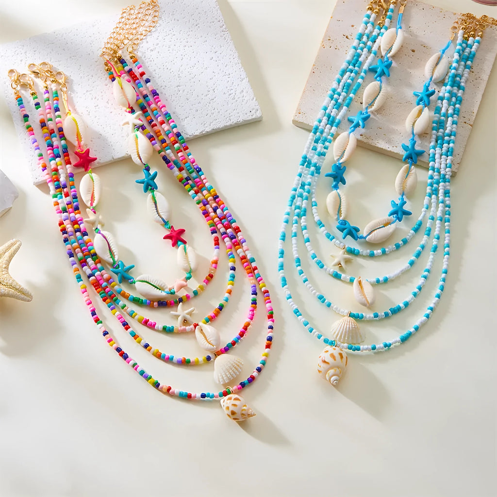 Blue electroplated women's necklace set with starfish and conch shell beads on adjustable chain