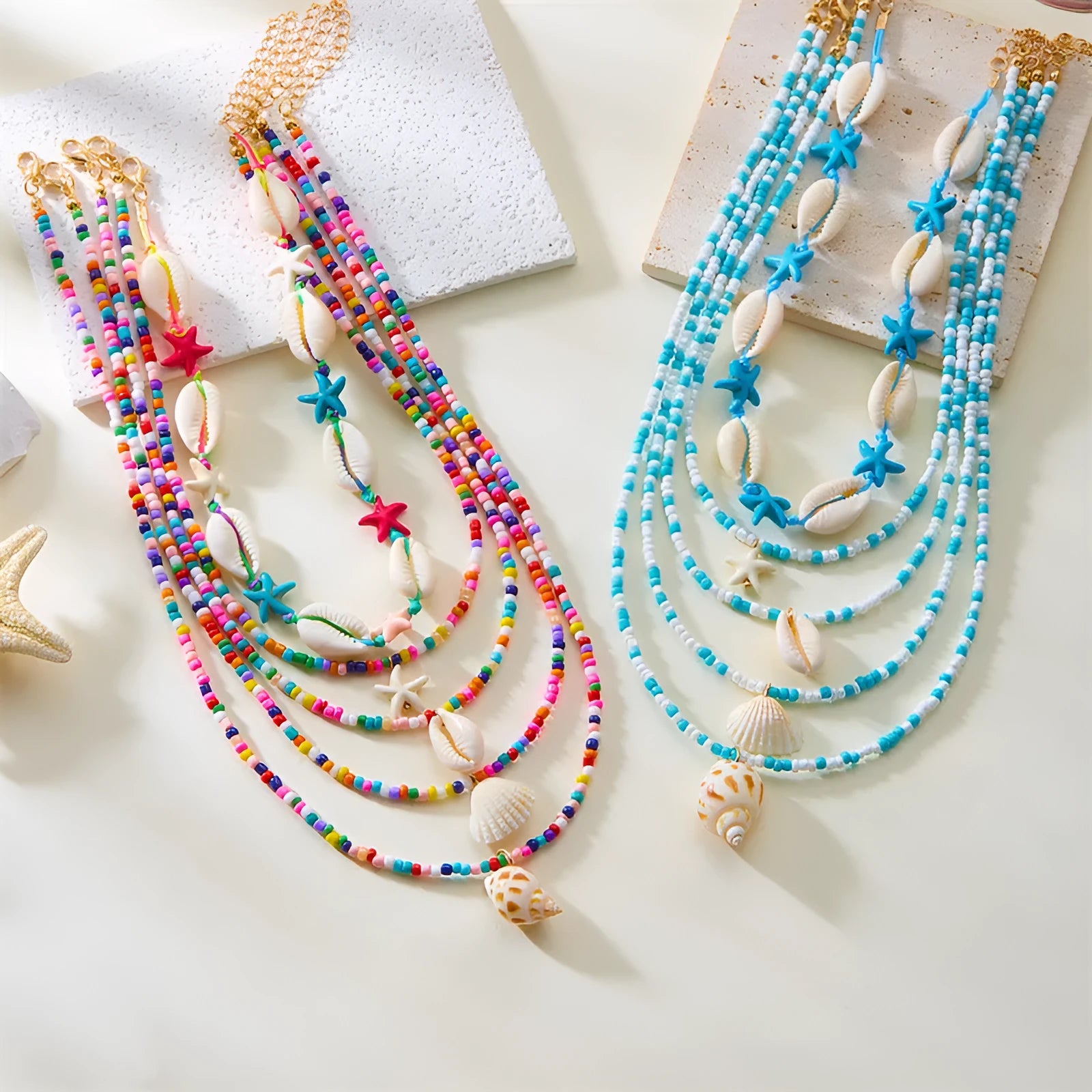 Blue electroplated women's necklace set with starfish and conch shell beads on adjustable chain