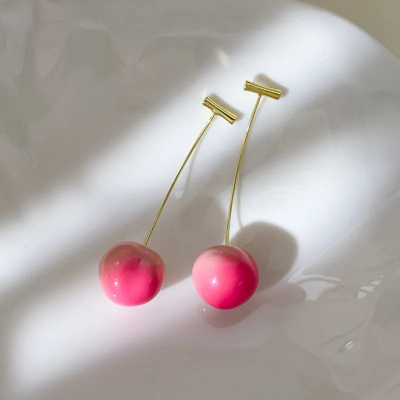 Gold-tone acrylic peach fruit earrings for women in small and large sizes.