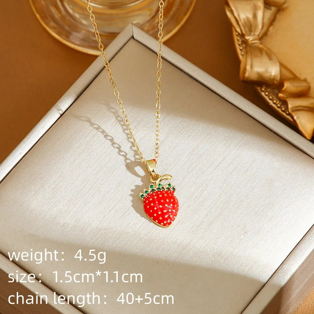 Red delicate indie necklace with cherry, strawberry, and pepper charms on a titanium steel O-ring chain.
