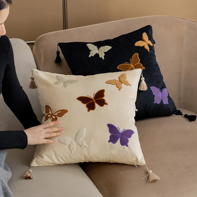 Square decorative cushion with Chinese-style butterfly embroidery in beige, black, and purple colours.