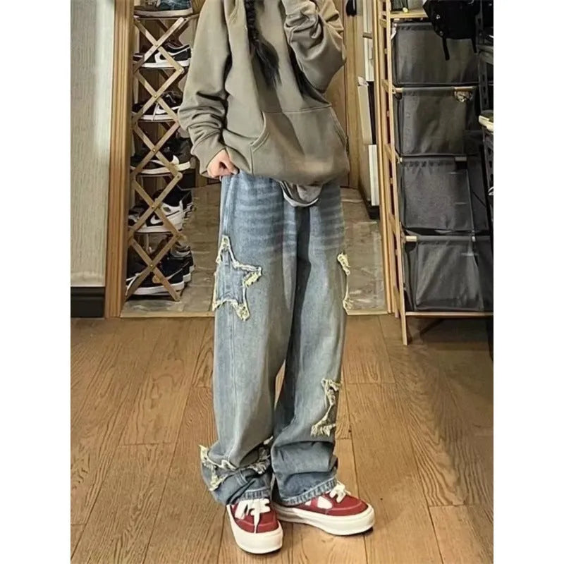 Blue high waist straight leg jeans for women laid flat, showing the denim texture and classic cut.