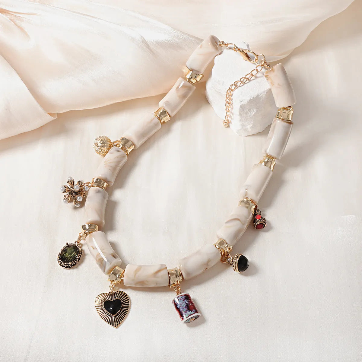 Women's bamboo design heart-shaped resin pendant necklace with electroplated finish.