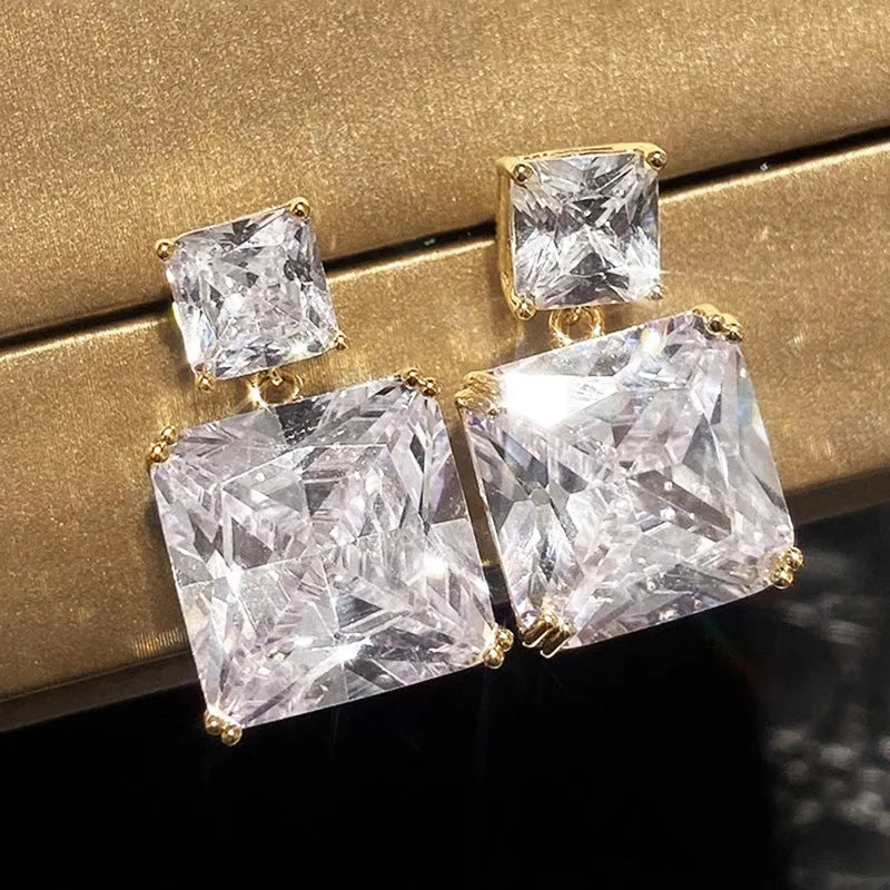 A pair of geometric square copper earrings for women in a choice of gold or white gold tone.