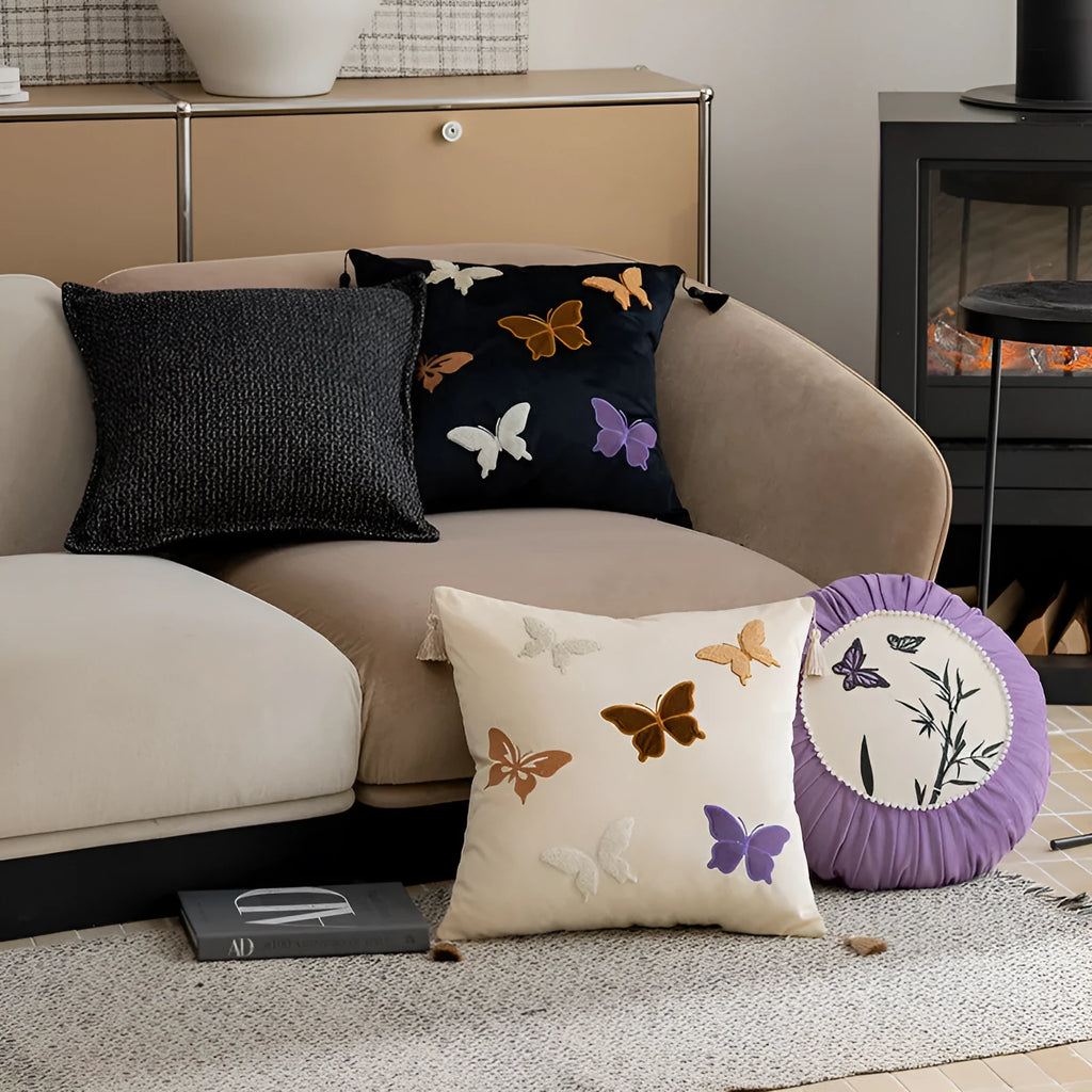 Square decorative cushion with Chinese-style butterfly embroidery in beige, black, and purple colours.