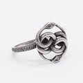 Close-up of a retro double snake coil ring in steel colour titanium steel on a model's hand.