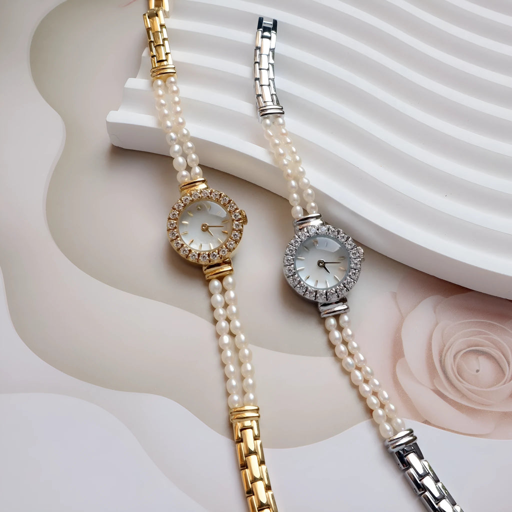 Light gold women's bracelet watch with freshwater pearls and a round 18mm dial.