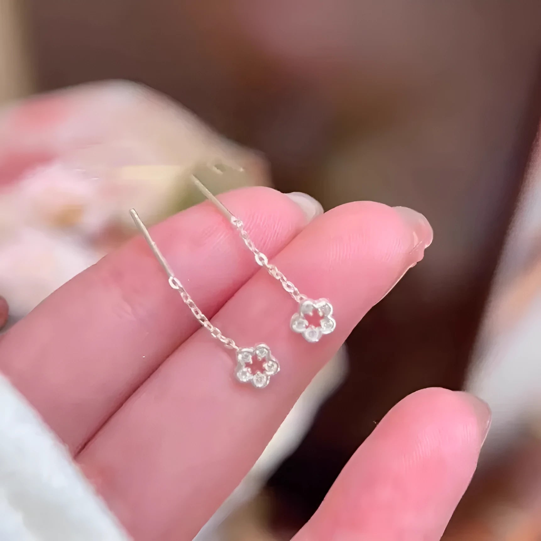 Silver-coloured alloy hollow flower hanging earrings with petal details on sterling silver needles