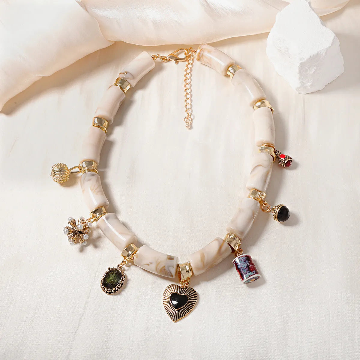 Women's bamboo design heart-shaped resin pendant necklace with electroplated finish.