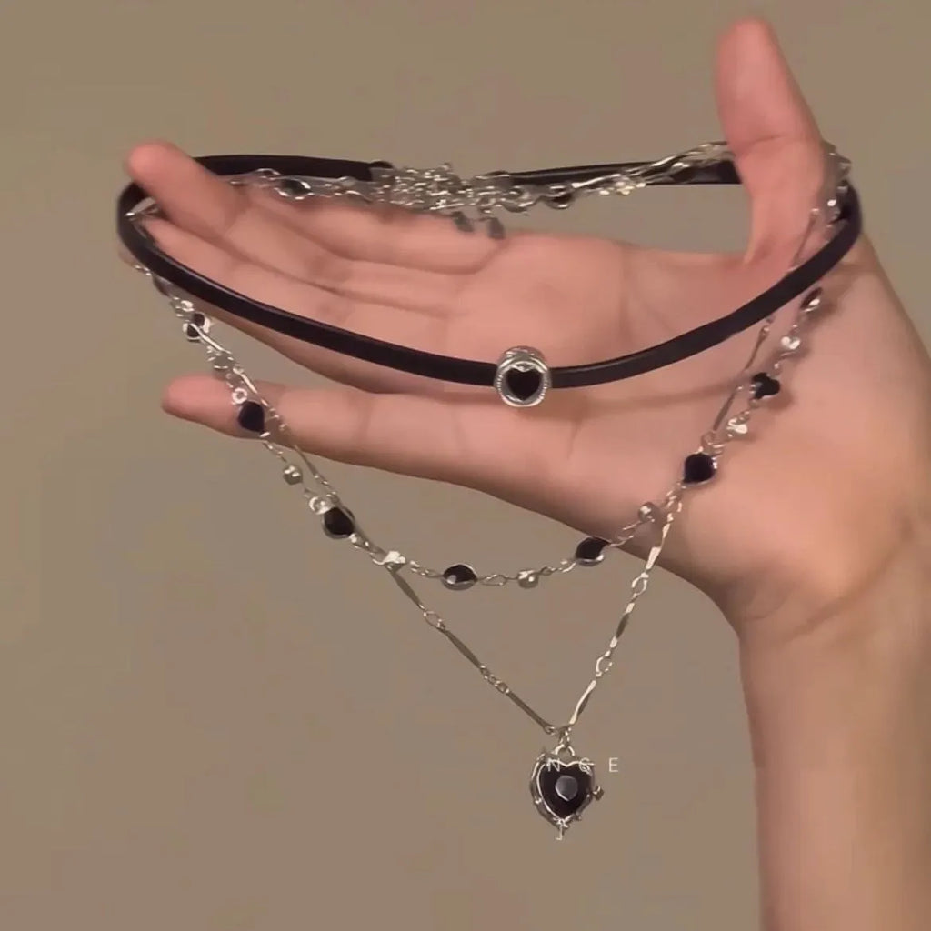 Women's leather and alloy double-layer heart pendant necklace on an adjustable clavicle chain.