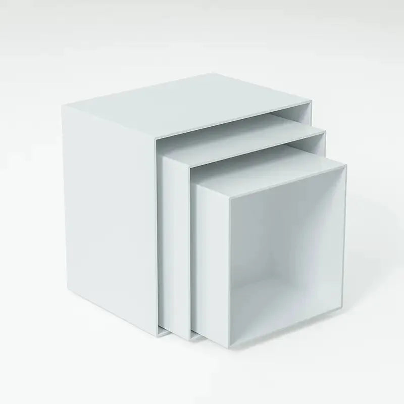 Set of six white plastic dessert display stands arranged on a tabletop.