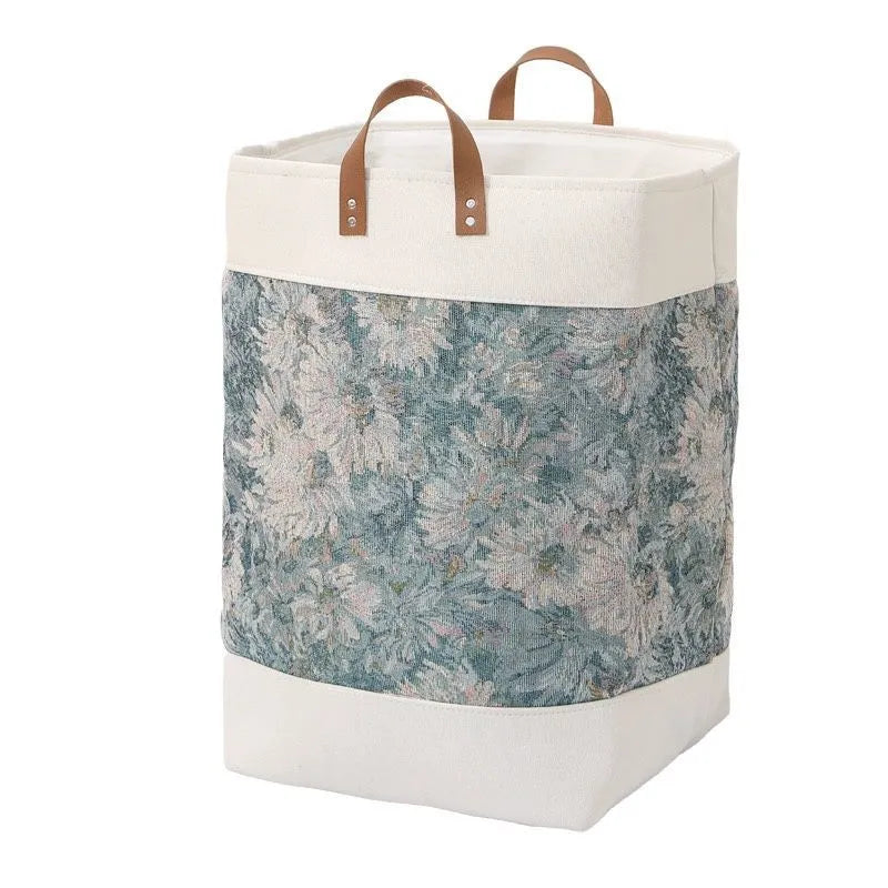 35cm cubed fabric storage bag in a colourful bear print, shown containing a folded quilt.