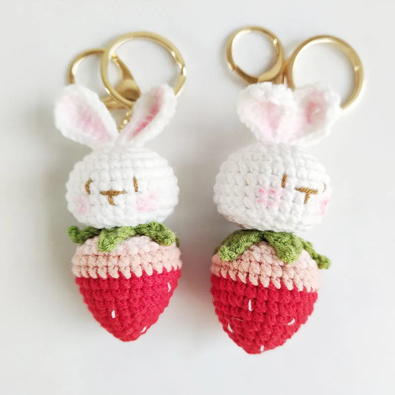 Hand-woven white rabbit strawberry wire pendant charm on a keyring.