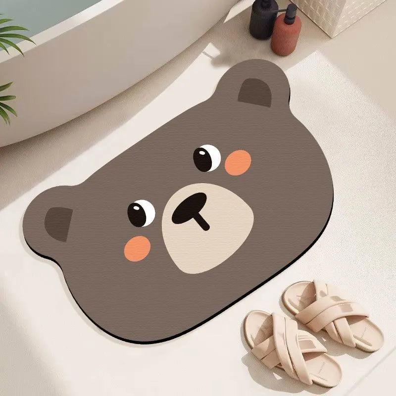 Cartoon animal diatom absorbent bathroom mat in bear pattern on tiled floor.
