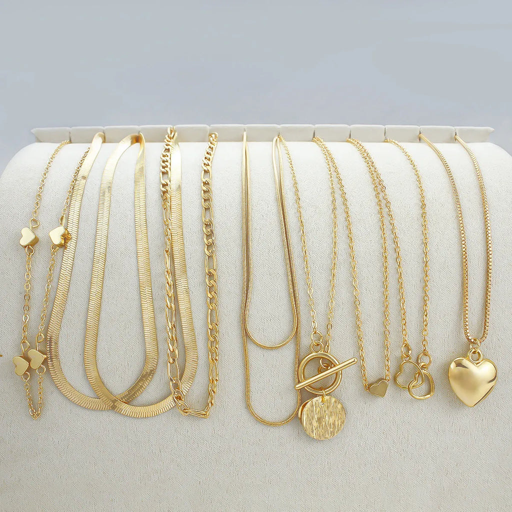 Gold women's 10-piece necklace set with alloy pendant on an adjustable snake bones chain.