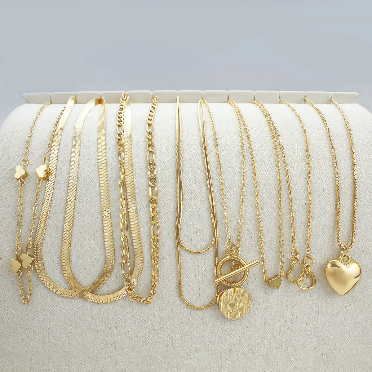 Gold women's 10-piece necklace set with alloy pendant on an adjustable snake bones chain.