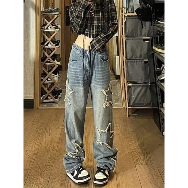 Blue high waist straight leg jeans for women laid flat, showing the denim texture and classic cut.