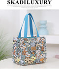 Women's printed canvas tote bag with aluminium handles in a floral or cat design.