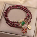 Women's crystal bracelet in pomegranate red cherry blossom colour with simple sequin detail on wrist