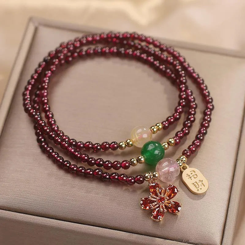 Women's crystal bracelet in pomegranate red cherry blossom colour with simple sequin detail on wrist