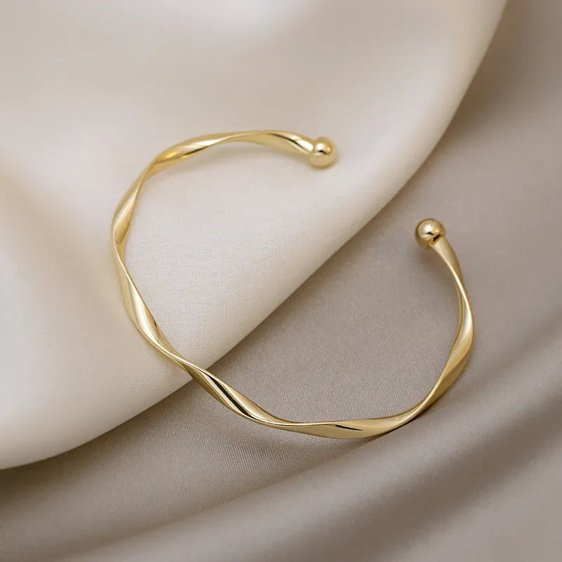 Gold twisted alloy bracelet with geometric Korean style design and 6.2cm inner ring diameter