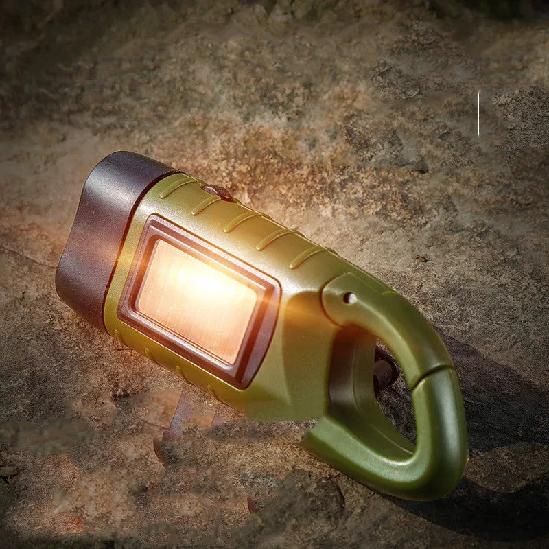 Olive green hand-crank solar LED flashlight with USB charging port on a compact black body.