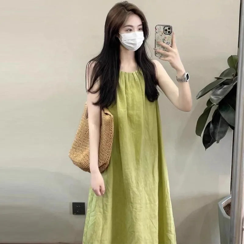 Plus size sleeveless asymmetric cotton blend vest skirt in green with matching black trousers, mid-length street fashion style