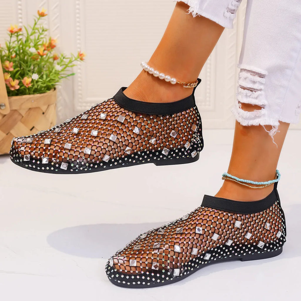 Women's flat mesh sandals with colourful rhinestone detail on a white background.