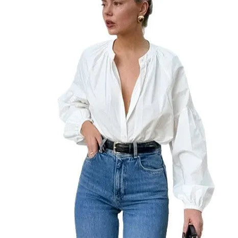 White women's button front long sleeve loose fit polyester shirt on plain background