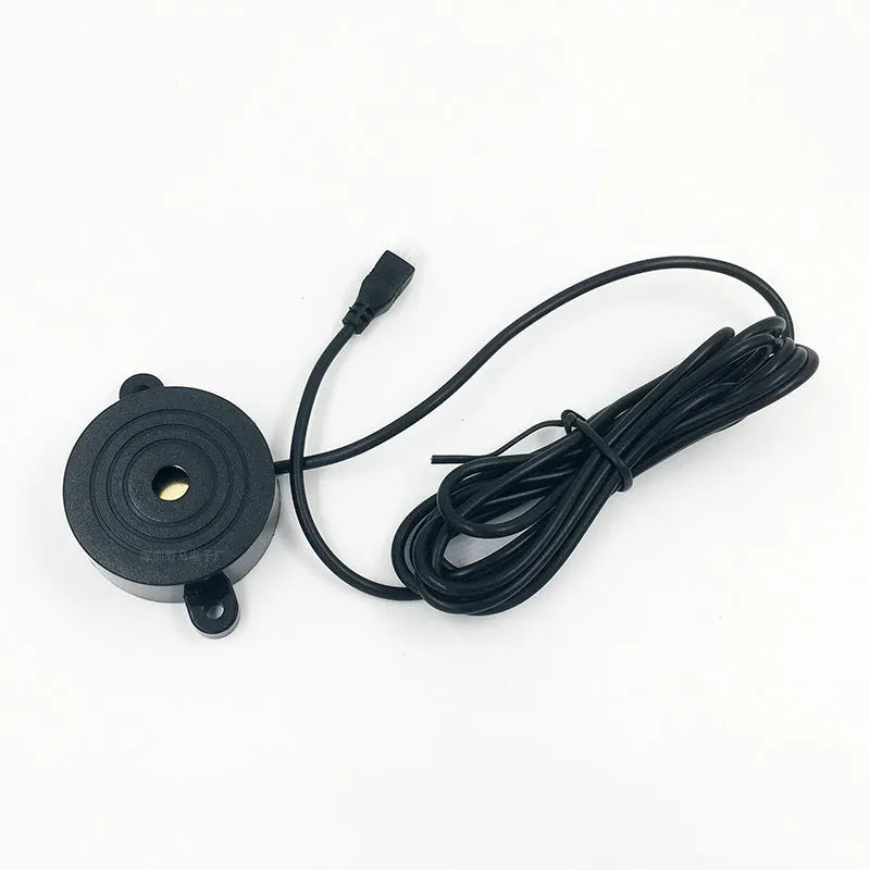 4-probe buzzer-only car reversing radar kit with sensors, control module, and hole saw on a grey background.