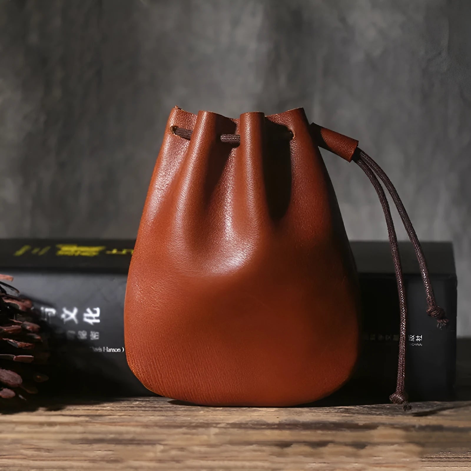 Vintage brown genuine leather drawstring bundle wallet with cinched closure.